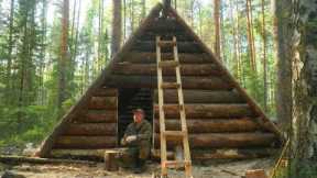 A MAN BUILDS A LARGE LOG CABIN ALONE. HOUSE IN THE WILD FOREST.
